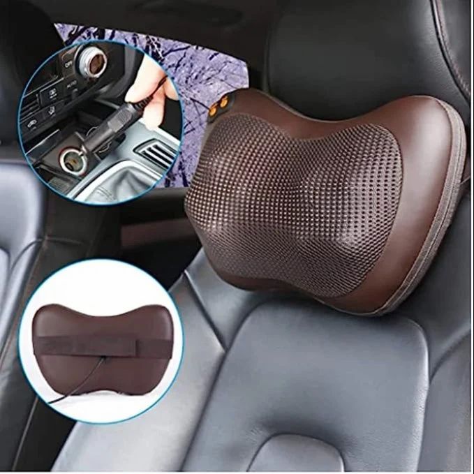 HaloRest massage pillow fixed to a car seat, shown with its 12V car adapter