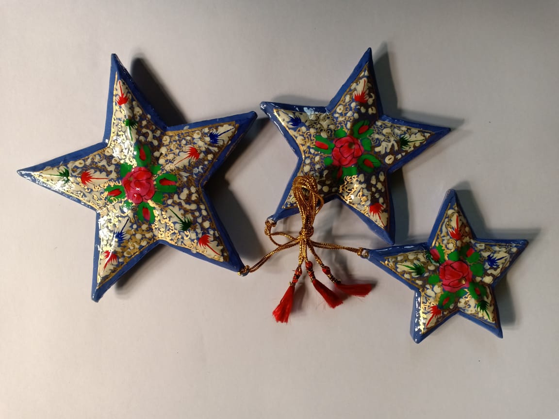 Hand-painted papier-mache star ornaments, white with red flowers and blue edge