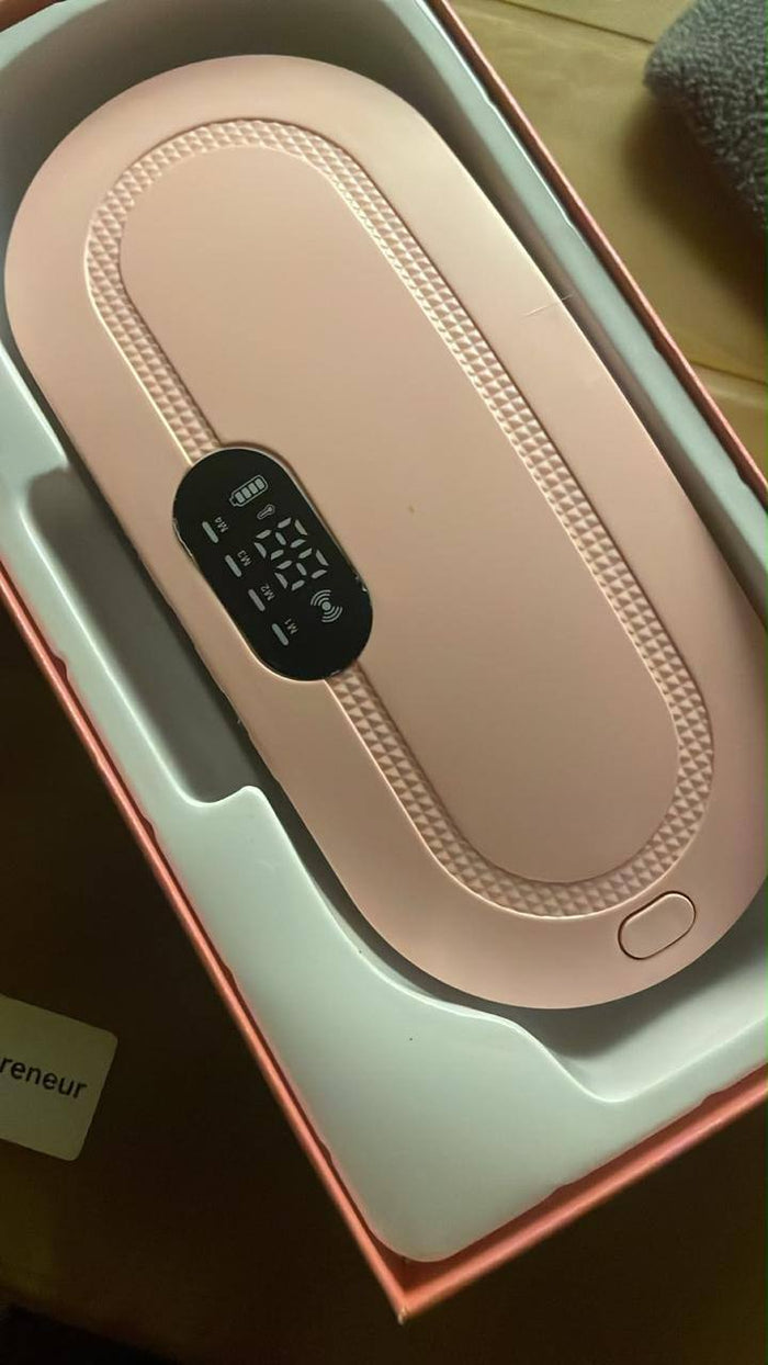 Real photo of the HaloCalm period heating belt in its box, LED display showing