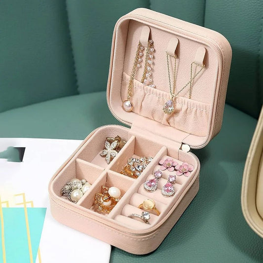 Jewellery organizer box open with rings, earrings and necklaces