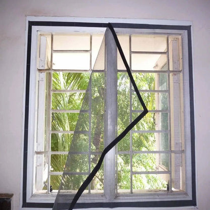 HaloMesh Window net fixed with hook-and-loop tape inside a grilled window frame, one corner peeled back